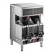 A Curtis stainless steel commercial coffee machine with two black containers on top.