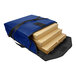 A blue and black Sterno Large Royal Blue Vinyl Insulated Pizza Carrier with several boxes inside.