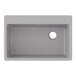 A Zurn Elkay Greystone Quartz drop-in sink with a drain hole on a counter.