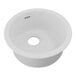 A Zurn Elkay Quartz white round sink with a hole in the middle.