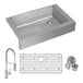 A Zurn stainless steel sink with a faucet, drain, and grid on a counter.