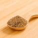 A wooden spoon filled with brown Rainforest Supply Chia Powder.