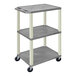 A gray rectangular Luxor plastic utility cart with three shelves and wheels.