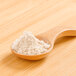 A wooden spoon filled with Rainforest Supply Amaranth Powder.