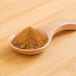 A wooden spoon filled with Rainforest Supply Acerola powder.