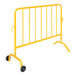 A yellow metal fence with wheeled feet.