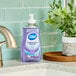 A bottle of Dial Lavender & Jasmine Liquid Hand Soap on a white counter.