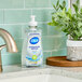 A bottle of Dial White Tea Liquid Hand Soap on a counter.