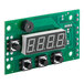 A green circuit board with a digital display and black buttons.