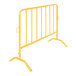 A yellow metal crowd control barrier with curved feet.