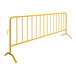 A yellow steel crowd control barrier with curved feet.