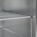 A metal shelf with shelves and holes in a metal cabinet.