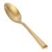 A Front of the House Matte Brass Demitasse Spoon with a long handle.