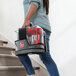 A woman carrying a Hoover ONEPWR CleanSlate cordless spot cleaner up stairs.