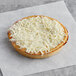 A Tony's Deep Dish Whole Grain cheese pizza on a piece of paper.