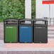 A row of Rubbermaid black and green decorative panels on trash cans.