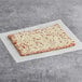 A rectangular Tony's SMARTPIZZA with cheese on it on a white paper.