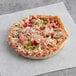 An Individually wrapped Tony's Deep Dish Supreme Pizza on a paper.