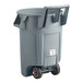 A grey Rubbermaid wheeled garbage can.