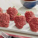A plate of strawberries with Yum Crumbs Red Velvet Topping on top.