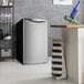 A Danby Iridium Silver reach-in refrigerator in a kitchen with a wine rack.