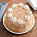 A birthday cake with Yum Crumbs Birthday Cake crumb topping and candles on top.