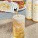 A hand pouring Wild Bill's Craft Beverage Co. Ginger Ale from a can into a glass.