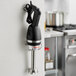 A Galaxy black and silver wall mount for an immersion blender.