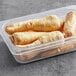 A plastic container of fresh parsnips.