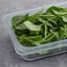 A plastic container of Fresh Teen Spinach on a counter.