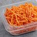 A plastic container of Fresh 1/16" Shredded Carrots.