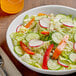 A bowl of 50/50 iceberg and romaine lettuce salad with vegetables.