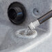 A water pouring out of a hose connected to a Lavex double mobile hand wash station.