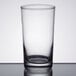 A Libbey clear heavy base highball glass on a table with a white background.