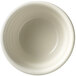 A close-up of a Libbey Porcelana cream white porcelain bouillon bowl with rolled edges.