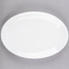 A white oval Libbey Porcelana coupe platter on a gray surface.