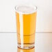 A Libbey Heavy Base cooler glass filled with beer on a table.