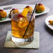 A Reserve by Libbey Modernist double old fashioned glass with a drink and a cherry on top.