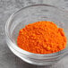 A bowl of Chefmaster Orange dry powder food color.