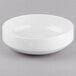 A Libbey Porcelana white porcelain bowl on a gray surface.