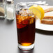 A Libbey Heavy Base Cooler Glass of iced tea with a lemon wedge.