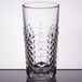 A close-up of a Libbey Carats clear beverage glass with a diamond cut design.