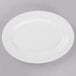 A Libbey Porcelana white porcelain platter with a white rim on a gray surface.