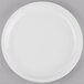 A Libbey Porcelana bright white porcelain plate with a white rim on a gray surface.