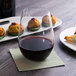 A Reserve by Libbey Renaissance stemless wine glass on a table with food