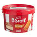 A red pail of Lotus Biscoff creamy cookie butter with a red lid.