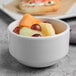 A bowl of fruit in a Libbey Porcelana bright white porcelain bowl.