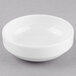 A Libbey Porcelana white porcelain bowl on a gray surface.