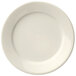 A close-up of a Libbey Porcelana cream white plate with a wide white rim.