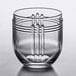 A clear Libbey rocks glass with a curved line design.